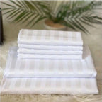 Supplier reference photo of the striped cotton bedsheet set folded, showing white striped fabric