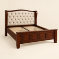 Button-tufted wingback solid mahogany bed frame in a clean studio