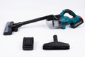 Teal-and-black cordless vacuum cleaner with extension tube, floor head, charging unit and broad attachment