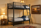 Black steel double-decker in warm evening guest bedroom